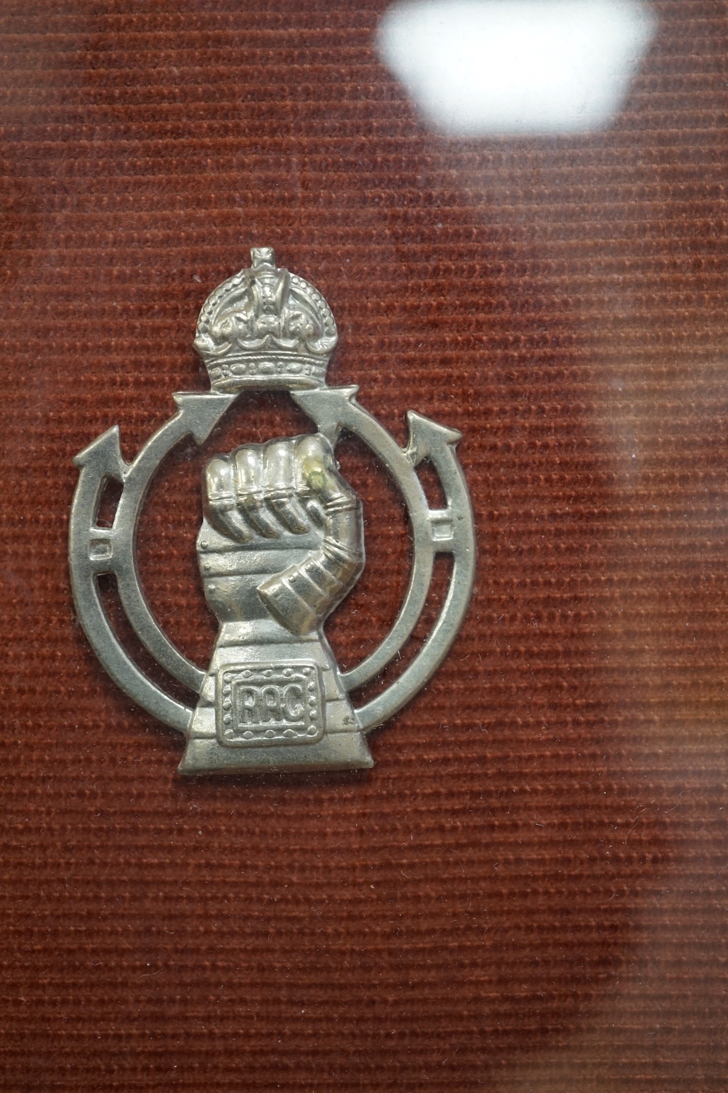 A framed collection of military cap Badges